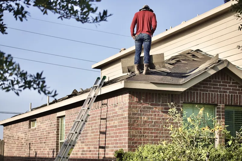 Professional roofer working on a residential roof in Shawan at Hunt Valley